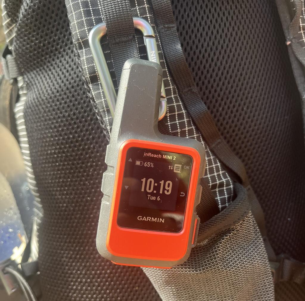 Garmin inReach Mini 2 Review. satellite communicator clipped to a backpack strap for trail safety